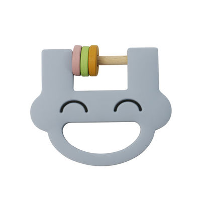 Il crepitio sveglio Teether del silicone dei giocattoli dei bambini del silicone del fronte di sorriso con personalizza il ODM dell'OEM di logo
